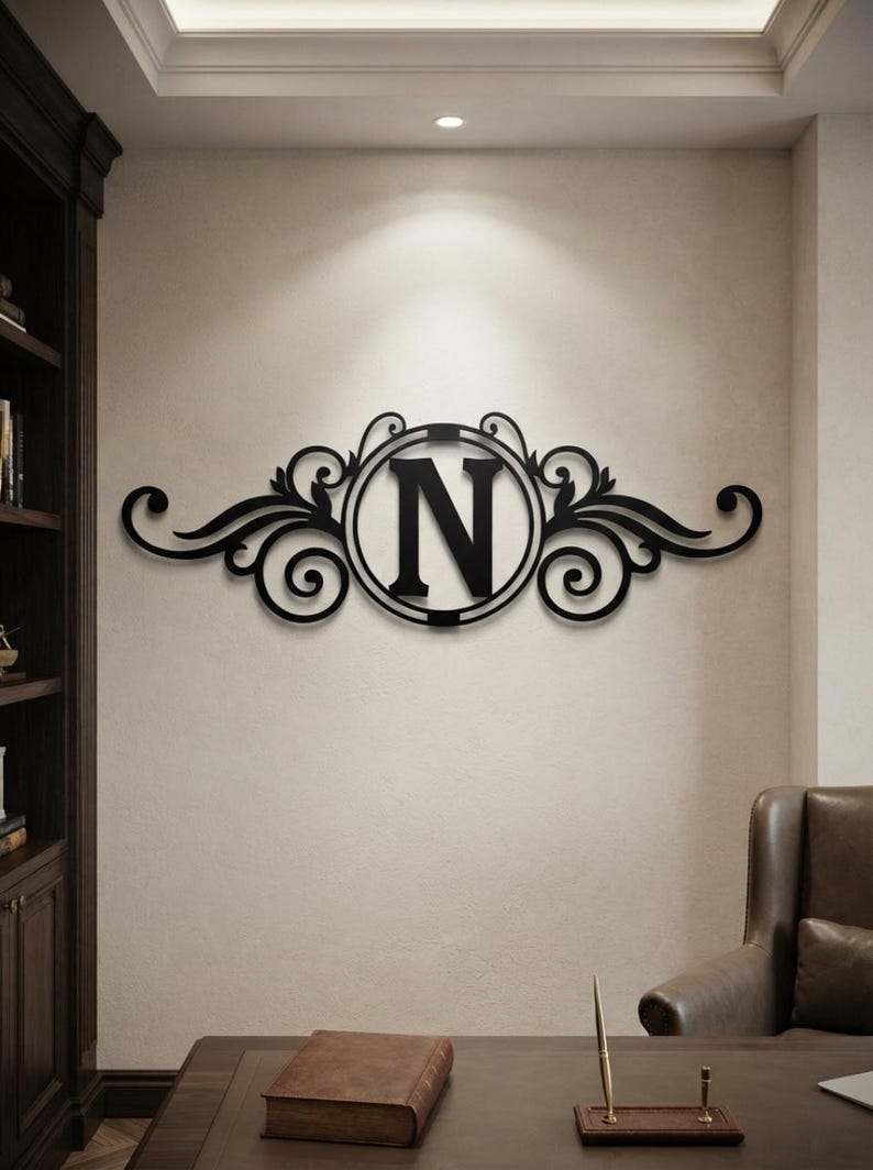 May include: A black wall-mounted sign featuring a central circular frame containing the capital letter N, flanked by symmetrical decorative scrollwork and leaf-like flourishes extending horizontally on both sides of the central letter.