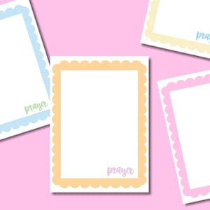 May include: Four rectangular stationery cards with scalloped borders in light blue, yellow, orange, and pink. Each card features a white center and the word prayer printed in a cursive script in the bottom right corner, matching the border color.