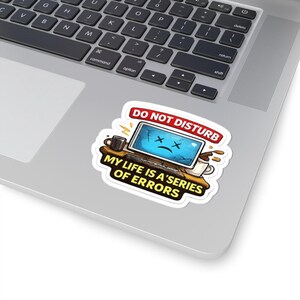 May include: A die-cut sticker featuring a cartoon computer with a cracked screen and a sad face, surrounded by coffee mugs. The text reads DO NOT DISTURB at the top and MY LIFE IS A SERIES OF ERRORS at the bottom in bold yellow and white lettering.