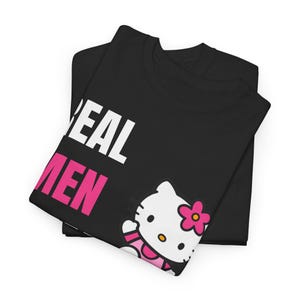 Może przedstawiać: Czarny t-shirt ze złożonym napisem "REAL MEN" w kolorze białym i r&oacute;żowym. Koszulka przedstawia grafikę Hello Kitty z r&oacute;żowym kwiatkiem.