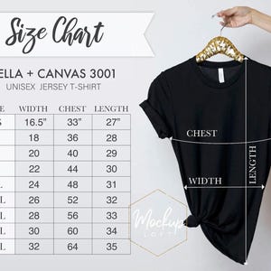 May include: A black Bella + Canvas 3001 unisex jersey t-shirt displayed on a gold hanger with an accompanying size chart. The chart lists sizes XS through 5XL with corresponding width, chest, and length measurements in inches for the garment.