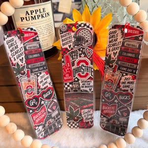 May include: Three rectangular bookmarks featuring Ohio State University themes in red, black, and white. Designs include football helmets, stadium imagery, heart-shaped sunglasses, iced coffee cups, and text like Good Girls Wear Scarlet & Gray.