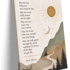 May include: A rectangular canvas wall art piece featuring a beige background with a golden sun, a crescent moon, and stars. A winding path leads through green and brown hills with pine trees and foliage. The text reads: May the sun bring you new energy by day, May the moon softly restore you by night, May the rain wash away your worries, May the breeze blow new strength into your being, May you walk gently through the world and know it's beauty all the days of your life. - Apache Blessing -