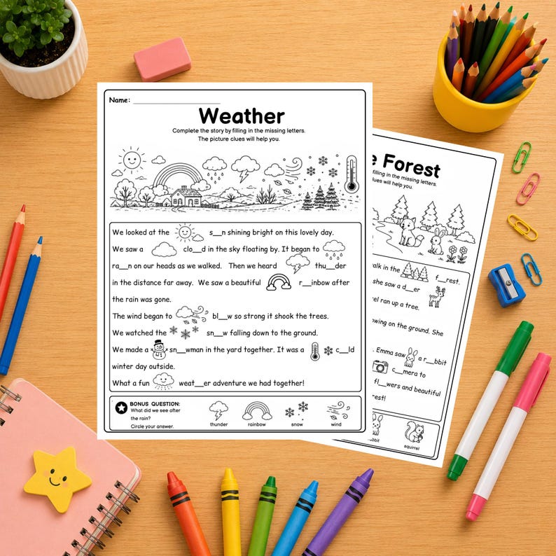 May include: Two educational worksheets titled Weather and The Forest featuring black and white line art illustrations and fill-in-the-blank sentences. The pages are surrounded by colored pencils, markers, a pink notebook, and a small potted plant.