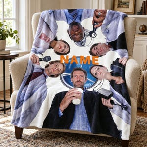 May include: A soft fleece throw blanket featuring a collage of five medical professionals in white lab coats arranged in a circle around the orange text NAME. The central figure holds a white coffee cup, while others hold medical diagnostic tools.