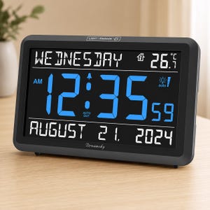 May include: A rectangular black digital clock with a large blue display showing 12:35:59 AM. The screen displays Wednesday, August 21, 2024, and a temperature of 26.7 degrees Celsius. The brand name Dreamsky is printed in white on the bottom frame.