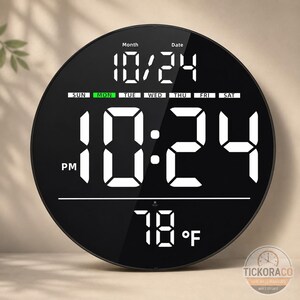 May include: A round black digital wall clock with a large white LED display showing the time 10:24 PM, the date 10/24, the day of the week MON, and the temperature 78 F. The clock face features a sleek, minimalist design with clear white digits.
