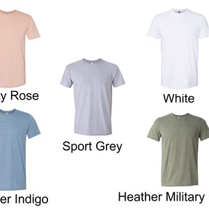 May include: Five different colored t-shirts, including dusty rose, white, sport grey, heather indigo, and heather military green.