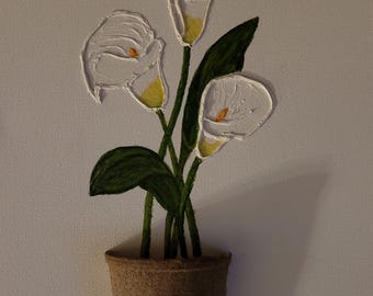 May include: A painting of three white calla lilies in a brown pot. The lilies have yellow centers and green leaves. The painting is signed "Alex Taylor" in the bottom right corner.
