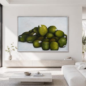 Può includere: Un'opera d'arte murale rettangolare che raffigura un grande e denso grappolo di oggetti rotondi color verde oliva con piccoli riflessi bianchi, su uno sfondo chiaro e uniforme, racchiusa in una sottile cornice dai toni metallici.