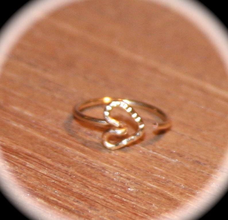 This item is a heart nose ring or cartilage earring. It is a handmade hoop style piercing that is also called an endless hoop or seamless hoop. A customer favorite!