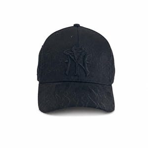May include: A black baseball cap featuring a tonal embroidered NY logo on the front panel. The cap is decorated with a subtle, matching black flame-like pattern embossed across the crown and the curved brim, creating a monochromatic look.