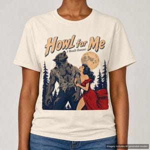 May include: A cream-colored t-shirt featuring a graphic print of a werewolf and a person in a red dress standing in a forest under a full moon. The text "Howl for Me" and "A Moonlit Romance" is printed in a stylized font above the illustration.