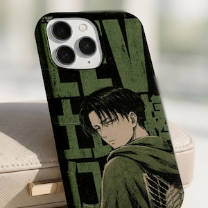 May include: A black smartphone case featuring a graphic illustration of a dark-haired character in a green hooded cloak. The background displays large, distressed green lettering and the text Survey Corps Notes in the lower corner.