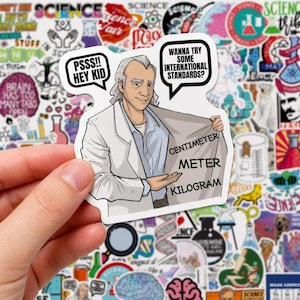 May include: A die-cut sticker featuring a cartoon illustration of a scientist with grey hair wearing a white lab coat. The character says PSSS!! HEY KID and WANNA TRY SOME INTERNATIONAL STANDARDS? The coat interior displays CENTIMETER, METER, KILOGRAM.