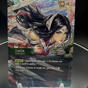 May include: A holographic trading card featuring the character Irelia Fervent from Ionia. The card displays a dynamic illustration of a dark-haired warrior with silver headgear, surrounded by blades. Text includes Deflect, ability details, and the quote Everyone has a purpose.