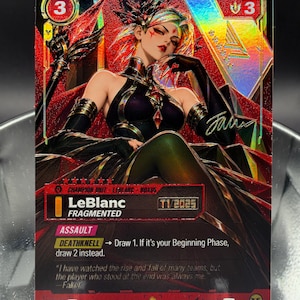 Könnte beinhalten: Eine holografische Sammelkarte mit der Figur LeBlanc aus League of Legends. Die Karte zeigt den Text LeBlanc Fragmented, Champion Unit, Noxus, Assault, Deathknell und ein Zitat von Faker. Sie hat ein Farbschema in Rot und Schwarz.