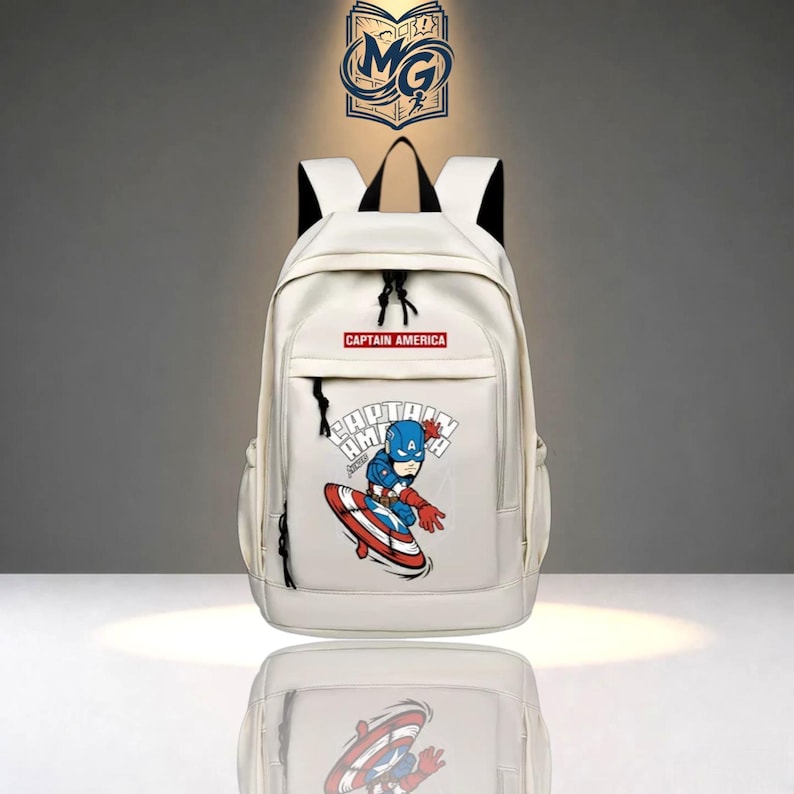 May include: A white backpack featuring a graphic of Captain America with a shield on the front pocket. The text "CAPTAIN AMERICA" is printed in a red rectangular box above the graphic. The bag has black straps and black zipper pulls.