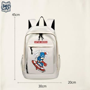 May include: A white backpack featuring a Captain America graphic and text. The bag has black straps and zippers, measuring 45cm in height, 30cm in width, and 20cm in depth. The front pocket displays a cartoon character with a shield and the text CAPTAIN AMERICA.