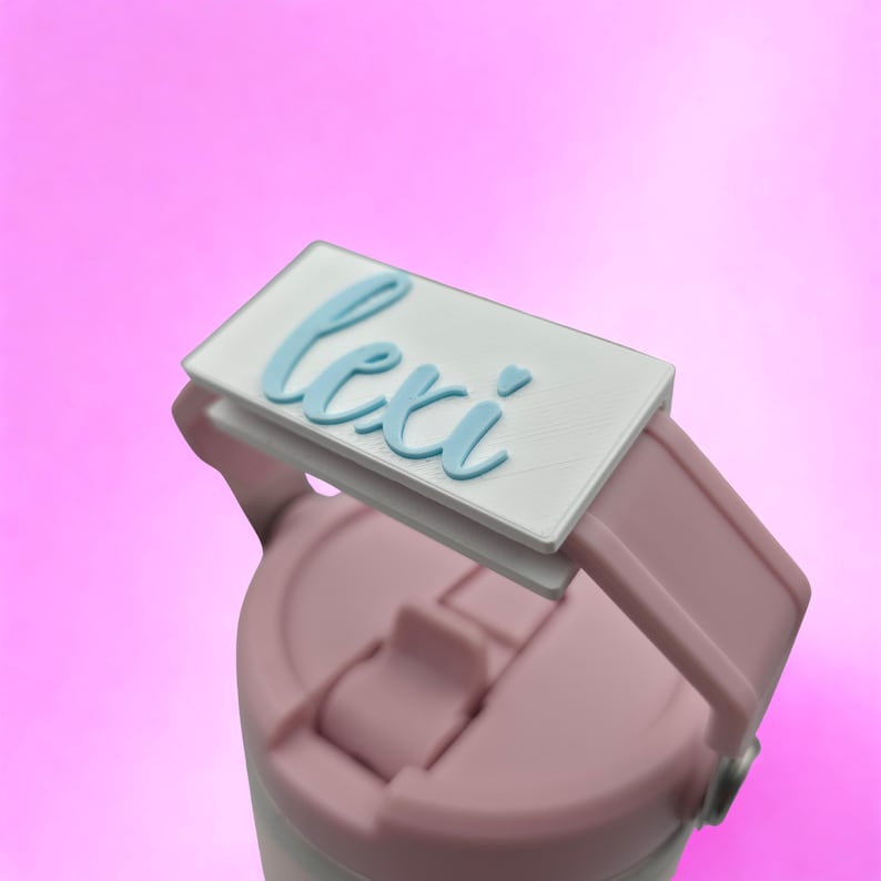 Close-up of custom 3D printed name tag attached to the handle of a Cherry Blossom Pink tumbler.