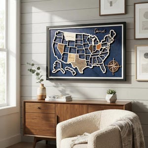 May include: A framed wall map of the United States featuring individual wooden state cutouts mounted on a dark blue background. The map includes a decorative compass rose in the lower right corner and the name Daniel written in script at the top.