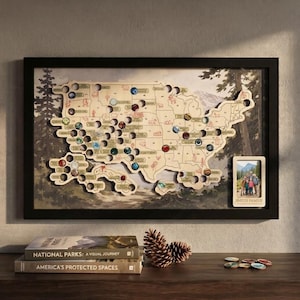 May include: A framed wooden map of the United States featuring circular cutouts for bottle caps, with a forest background and a small photo frame labelled SMITH FAMILY. The map includes state outlines and various small illustrations.
