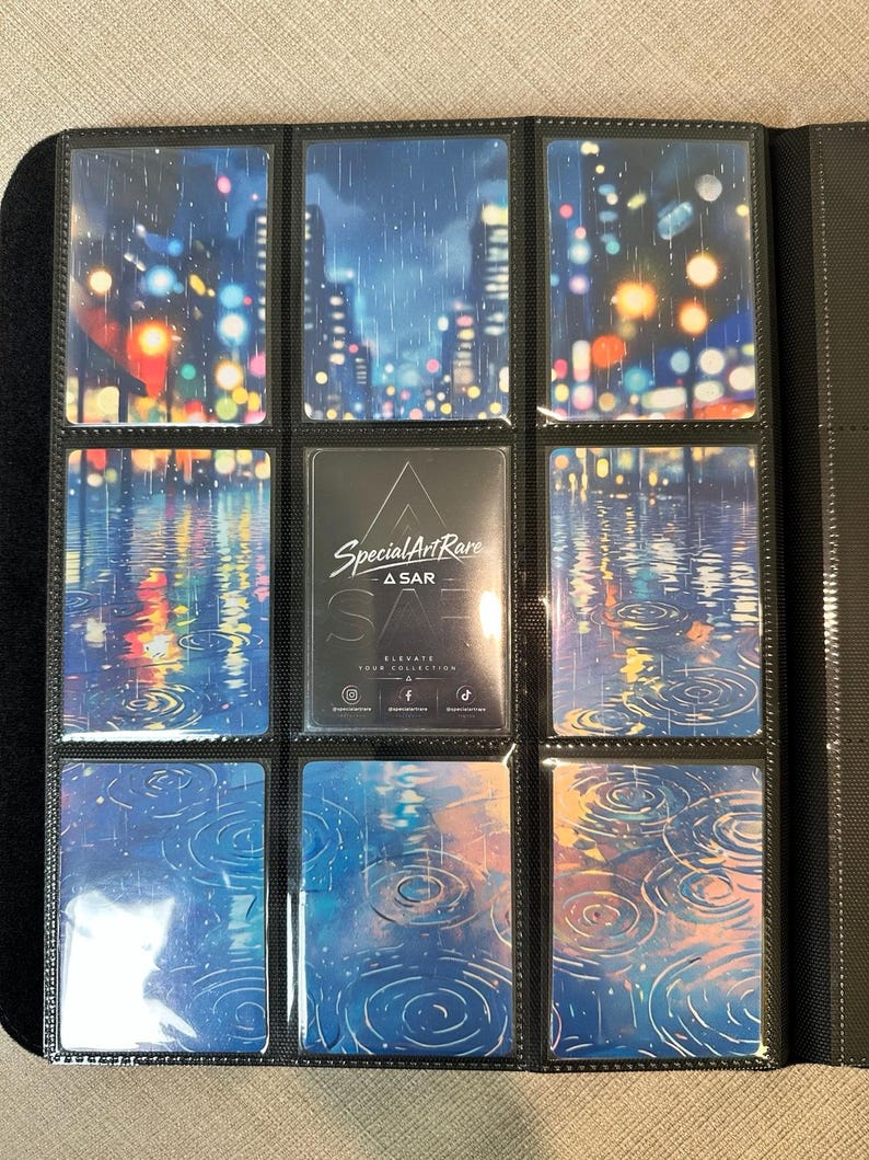 May include: A black trading card binder page containing nine slots. Eight slots feature cards with a rainy city night scene with colorful bokeh lights and water ripples. The center card is black with the white text Special Art Rare A SAR.