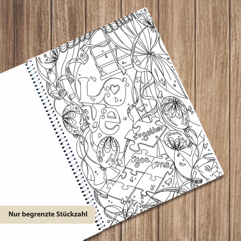 May include: A spiral-bound coloring book page featuring black and white line art with the word LOVE, puzzle pieces labeled together and you me, balloons, and ribbons. The design includes intricate patterns and a window motif for coloring.