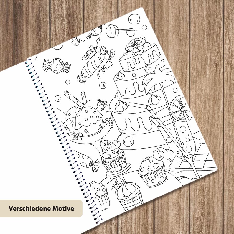 May include: A spiral-bound coloring book page featuring black and white line art of various desserts including a tiered cake, cupcakes, ice cream, and candies, with the text Verschiedene Motive printed in a small box at the bottom left corner.