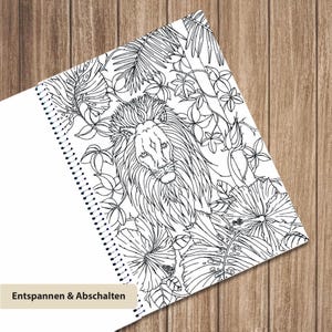 May include: A spiral-bound coloring book page featuring a detailed black and white line drawing of a lion surrounded by tropical hibiscus flowers and palm leaves. The bottom left corner includes a beige label with the text Entspannen & Abschalten.