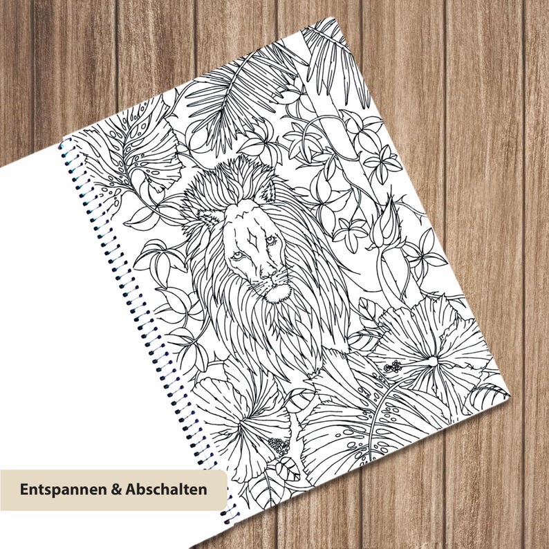 May include: A spiral-bound coloring book page featuring a detailed black and white line drawing of a lion surrounded by tropical hibiscus flowers and palm leaves. The bottom left corner includes a beige label with the text Entspannen & Abschalten.