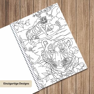 May include: A spiral-bound coloring book page featuring a black and white line art illustration of two tigers in a jungle setting. One tiger is standing on a rock in the background, while the other is a large close-up portrait in the foreground.