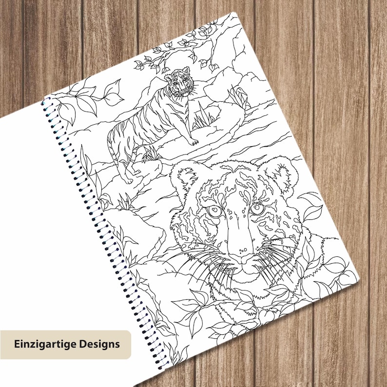 May include: A spiral-bound coloring book page featuring a black and white line art illustration of two tigers in a jungle setting. One tiger is standing on a rock in the background, while the other is a large close-up portrait in the foreground.