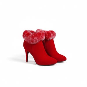 May include: A pair of vibrant red ankle boots featuring a high stiletto heel and a rounded toe. The top opening of each boot is trimmed with a thick, fluffy red and white faux fur collar. The boots have a smooth, matte finish and a side zipper.