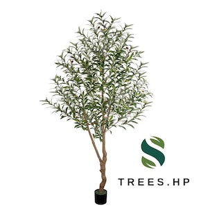 May include: An artificial olive tree with a slender, textured brown trunk and numerous green leaves. Small dark olives are scattered throughout the branches. The tree stands in a black cylindrical base. The logo TREES.HP is visible in the corner.