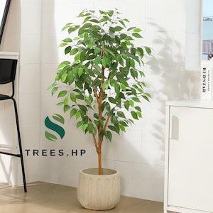 May include: An artificial ficus tree with vibrant green leaves and a brown trunk, potted in a textured, light beige cylindrical planter. The logo for TREES.HP is visible to the left of the plant, featuring a stylized green and dark teal leaf icon.