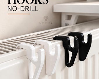 May include: Two white and two black radiator hooks designed for no-drill installation. The hooks feature a Y-shaped profile and are mounted on a white radiator. Text on the image reads RADIATOR HOOKS NO-DRILL, LYTHE, HEAT RESISTANT, and EASY TO INSTALL.