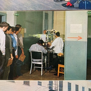 May include: A group of men stand in a line in a room with a dental exam room in the background. The room has a light blue wall with the words "Exam 2" written on it. The dental exam room has a dental chair and a dentist in a white coat.