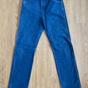 May include: A pair of dark blue denim jeans with a straight leg fit.