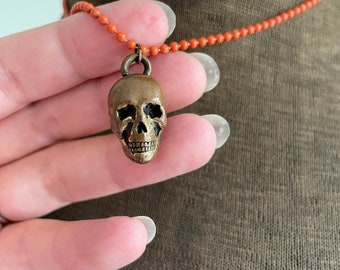 Vintage metal skull gum ball prize charm on orange bead chain