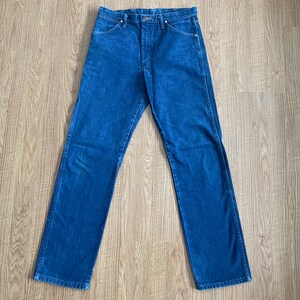 May include: A pair of blue denim jeans with a straight leg fit.