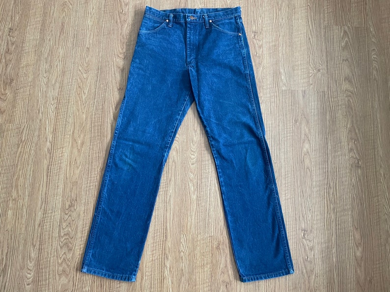 May include: A pair of blue denim jeans with a straight leg fit.