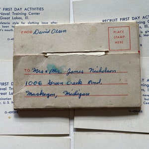 May include: Two vintage postcards with handwritten addresses. The top postcard is white with blue text and reads "First Day Activities Naval Training Center Great Lakes, III." The bottom postcard is white with blue text and reads "Recruit First Day Activities U.S. Naval Training Great Lakes, III."