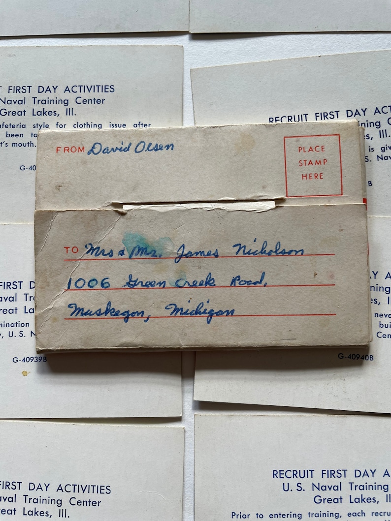 May include: Two vintage postcards with handwritten addresses. The top postcard is white with blue text and reads "First Day Activities Naval Training Center Great Lakes, III." The bottom postcard is white with blue text and reads "Recruit First Day Activities U.S. Naval Training Great Lakes, III."