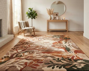 May include: A rectangular area rug featuring a textured, abstract pattern of organic, tree-like branches and foliage in shades of terracotta, deep forest green, beige, and cream, covering the floor of a room with light wood flooring.