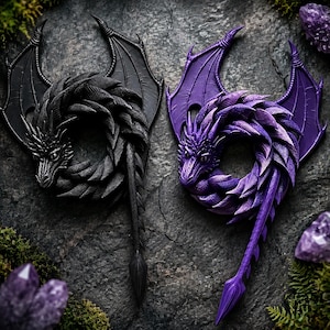 May include: Two coiled dragon sculptures, one solid black and one vibrant purple, each featuring intricate scale textures, large pointed wings, and a long tail. The dragons are positioned in a circular shape with their heads facing forward.