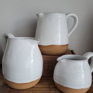 Hand thrown white tin glaze jugs