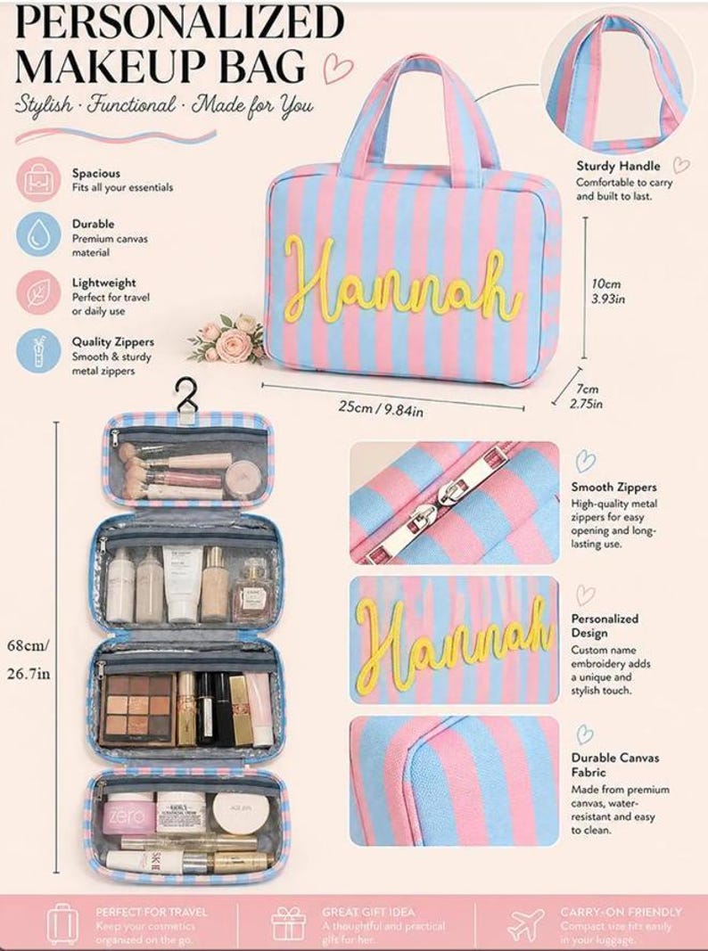 May include: A rectangular makeup bag with pink and blue vertical stripes, featuring the name Hannah in yellow script. It includes a top handle, metal zippers, and an interior with four zippered compartments for organizing cosmetics and toiletries.
