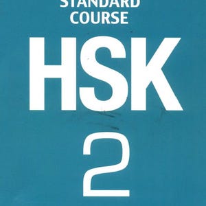 May include: A teal book cover featuring white text that reads Standard Course HSK 2, with the Chinese characters for Standard Course positioned above the English text. The large white letters HSK are centered, followed by the number 2 below.