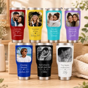 May include: Seven stainless steel tumblers in red, yellow, teal, purple, blue, black, and white. Each features a rectangular photo frame, personalised text, and a silver lid. The tumblers display various portraits and sentimental phrases.